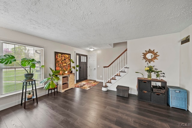 608 Budlong St, Adrian, MI 49221 - entrance foyer featuring wood finished floors, a textured ceiling, stairway, and baseboards