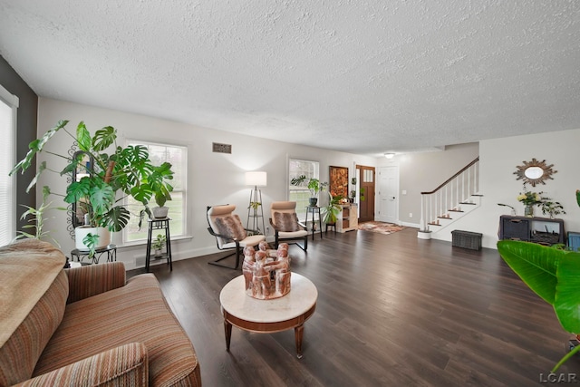 608 Budlong St, Adrian, MI 49221 - living area featuring a textured ceiling, stairs, wood finished floors, and baseboards