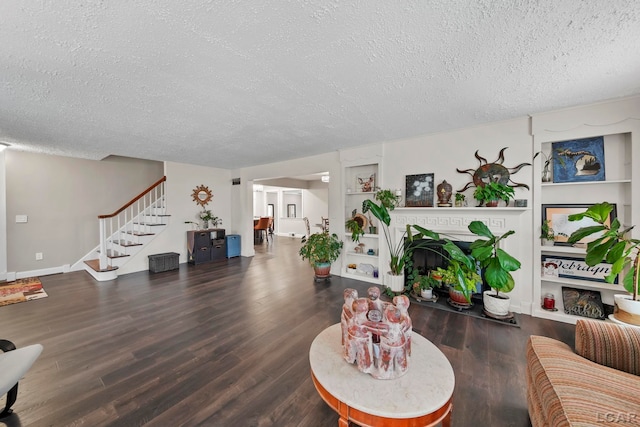 608 Budlong St, Adrian, MI 49221 - living area featuring a textured ceiling, wood finished floors, stairs, and a fireplace