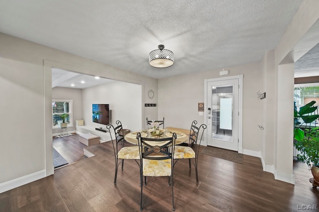 608 Budlong St, Adrian, MI 49221 - dining room with dark wood finished floors, baseboards, and a textured ceiling