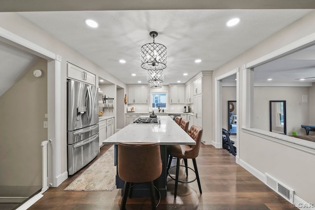 608 Budlong St, Adrian, MI 49221 - kitchen featuring stainless steel appliances, white cabinets, a center island, recessed lighting, and dark wood-style floors