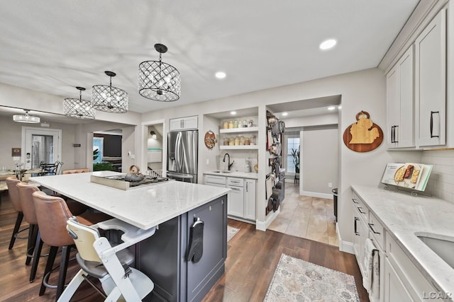 608 Budlong St, Adrian, MI 49221 - kitchen with stainless steel appliances, a sink, a kitchen breakfast bar, recessed lighting, and a center island
