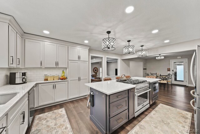608 Budlong St, Adrian, MI 49221 - kitchen with appliances with stainless steel finishes, gray cabinets, a chandelier, recessed lighting, and white cabinetry