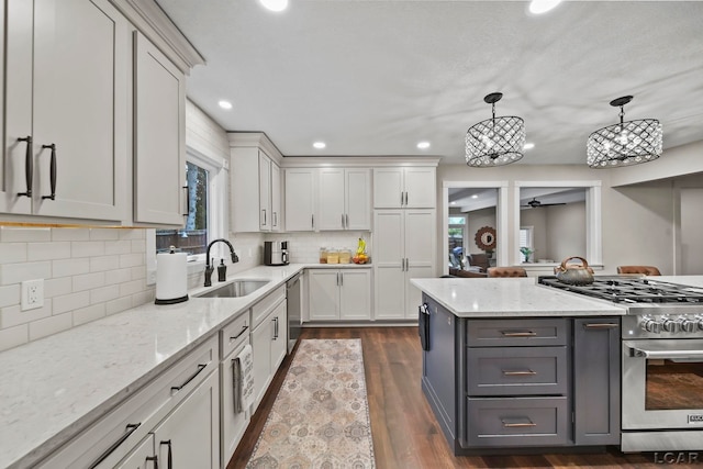 608 Budlong St, Adrian, MI 49221 - kitchen with appliances with stainless steel finishes, a sink, gray cabinetry, light stone countertops, and recessed lighting