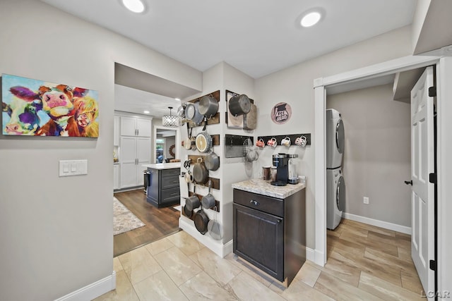 608 Budlong St, Adrian, MI 49221 - kitchen with estacked washer and dryer, light countertops, recessed lighting, and baseboards