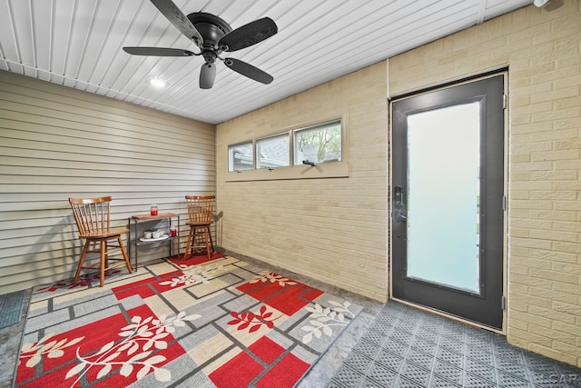 608 Budlong St, Adrian, MI 49221 - living area featuring brick wall and a ceiling fan
