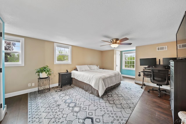 608 Budlong St, Adrian, MI 49221 - bedroom with a desk, wood finished floors, baseboards, a ceiling fan, and a textured ceiling