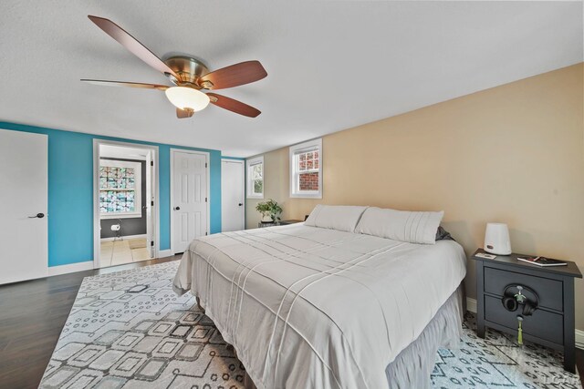 608 Budlong St, Adrian, MI 49221 - bedroom featuring baseboards, wood finished floors, ceiling fan, and multiple windows