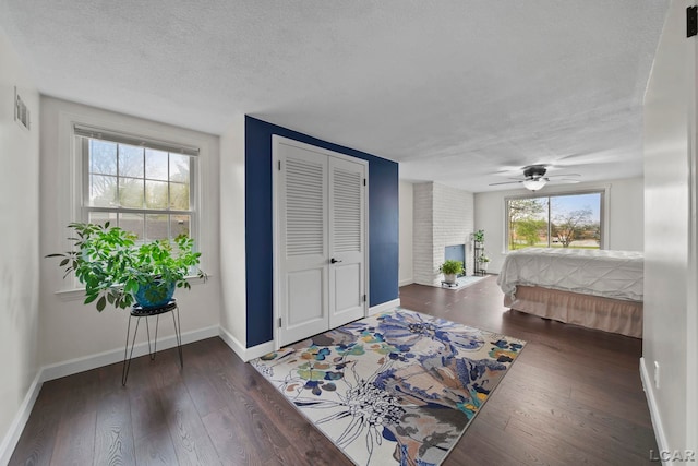 608 Budlong St, Adrian, MI 49221 - bedroom featuring baseboards, a textured ceiling, wood-type flooring, and a closet