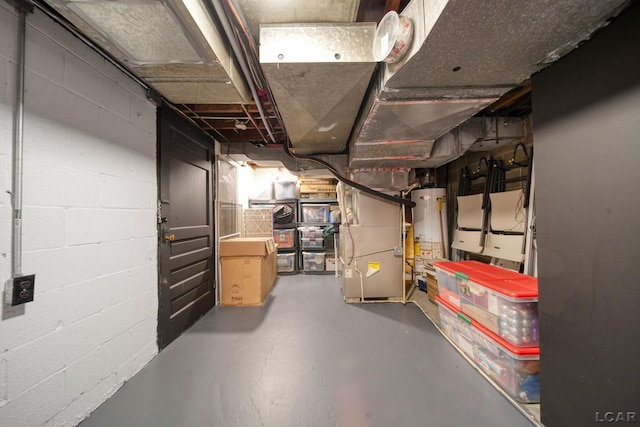 608 Budlong St, Adrian, MI 49221 - unfinished below grade area with water heater, heating unit, and concrete block wall