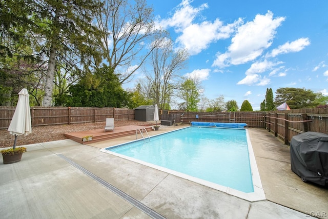 608 Budlong St, Adrian, MI 49221 - view of pool featuring a storage shed, a patio, a fenced backyard, and an outbuilding
