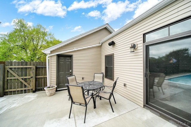 608 Budlong St, Adrian, MI 49221 - view of patio with a gate, outdoor dining area, and fence