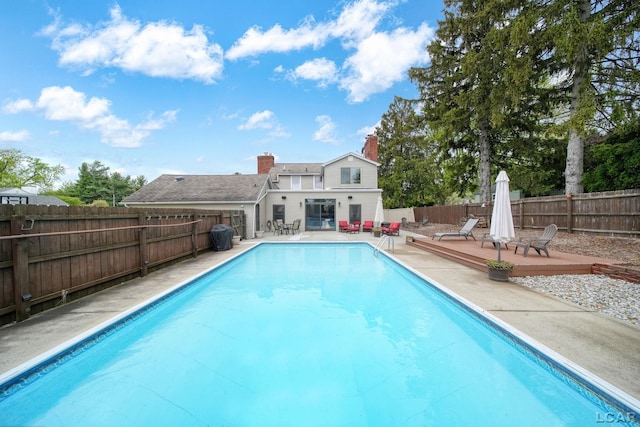 608 Budlong St, Adrian, MI 49221 - view of swimming pool featuring a fenced backyard, a wooden deck, and a patio