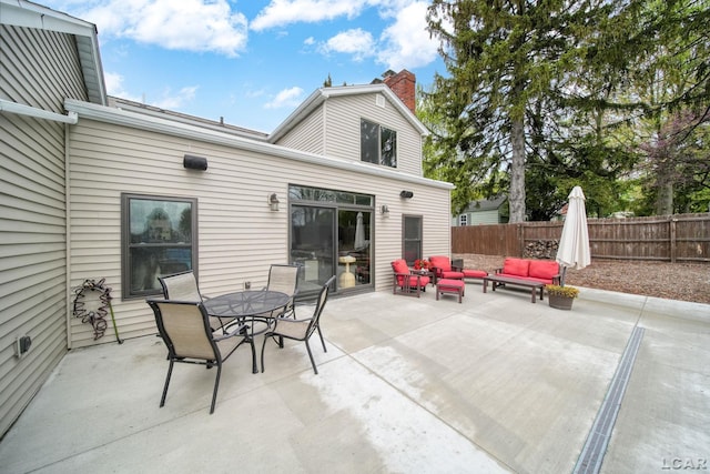 608 Budlong St, Adrian, MI 49221 - view of patio with an outdoor hangout area, fence, and outdoor dining area