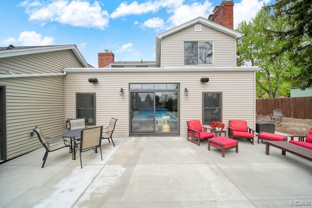 608 Budlong St, Adrian, MI 49221 - rear view of property with a chimney, a patio, fence, and an outdoor hangout area