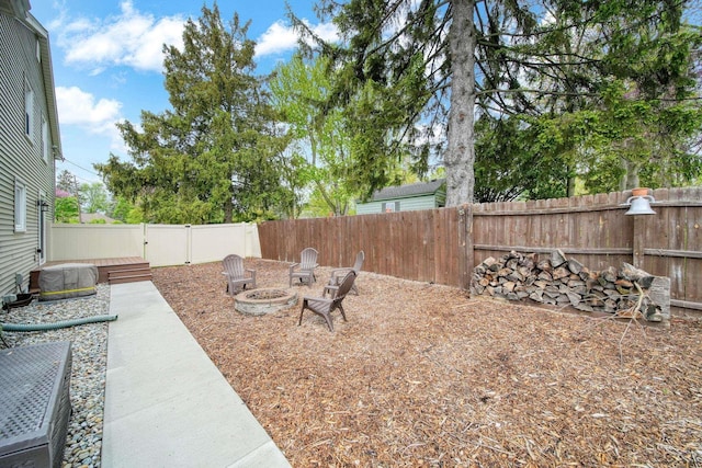 608 Budlong St, Adrian, MI 49221 - fenced backyard with an outdoor fire pit