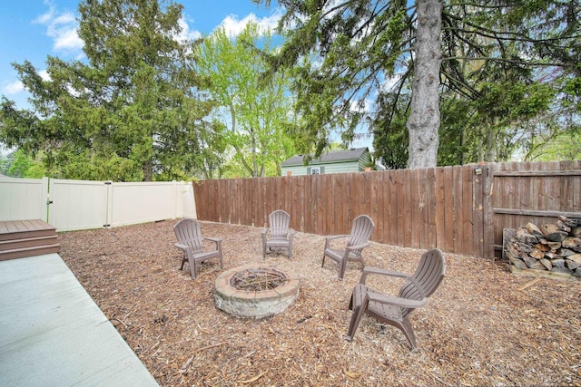 608 Budlong St, Adrian, MI 49221 - fenced backyard with an outdoor fire pit and a gate