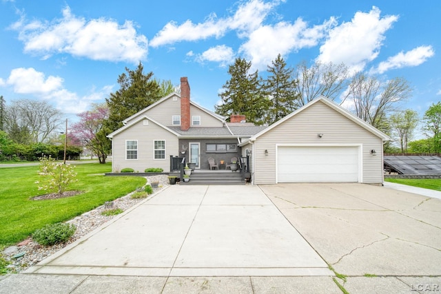 608 Budlong St, Adrian, MI 49221 - view of front of home with a garage, driveway, a front lawn, and a chimney