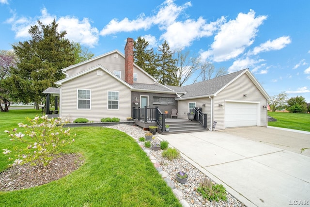 608 Budlong St, Adrian, MI 49221 - view of front facade featuring a garage, concrete driveway, a wooden deck, and a front yard