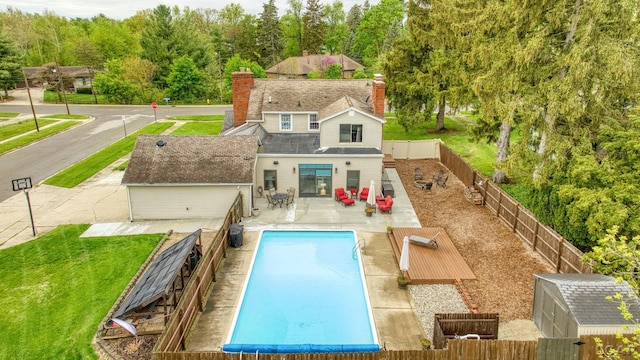 608 Budlong St, Adrian, MI 49221 - view of pool with a fenced backyard, a patio area, and an outbuilding
