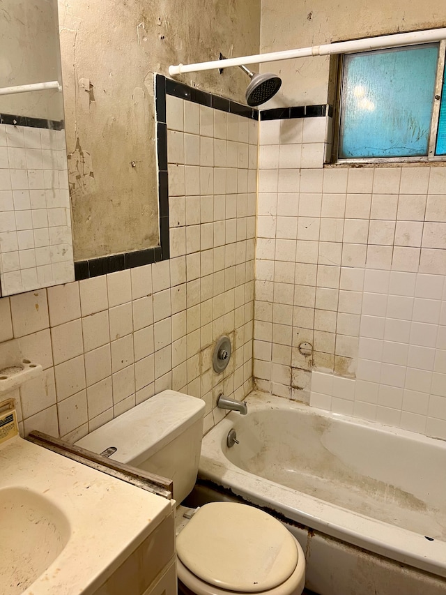 2209 Kansas Ave, Flint, MI 48506 - bathroom featuring tile walls,  shower combination, toilet, and vanity