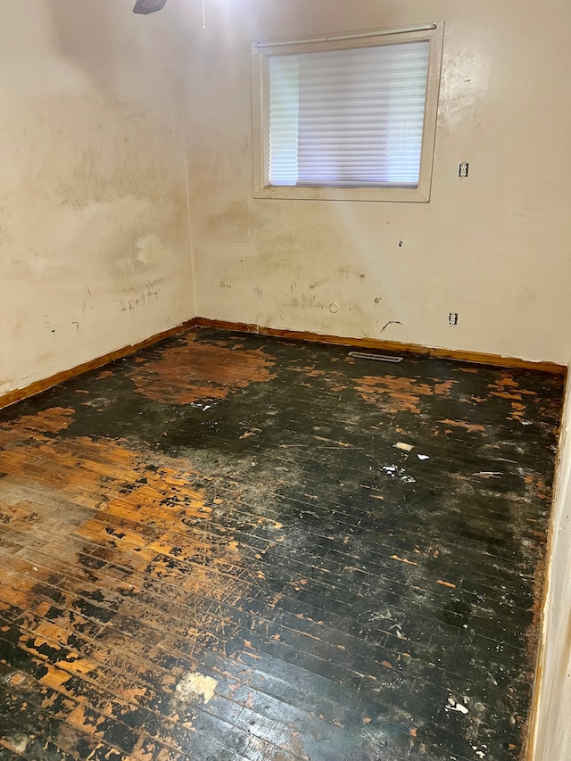2209 Kansas Ave, Flint, MI 48506 - unfurnished room with baseboards and hardwood / wood-style flooring