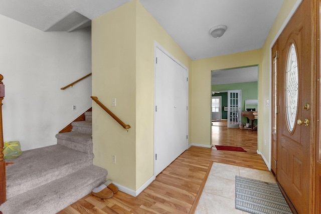512 Kalkaska Rd NW, Kalkaska, MI 49646 - foyer entrance featuring light wood-type flooring, stairs, and french doors