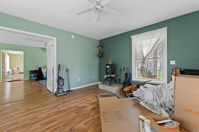 512 Kalkaska Rd NW, Kalkaska, MI 49646 - living room with wood finished floors, a ceiling fan, and baseboards