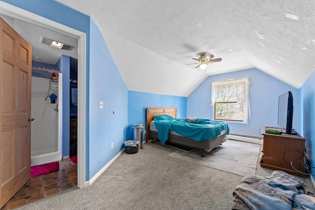512 Kalkaska Rd NW, Kalkaska, MI 49646 - carpeted bedroom featuring vaulted ceiling, a baseboard heating unit, baseboards, ceiling fan, and a textured ceiling