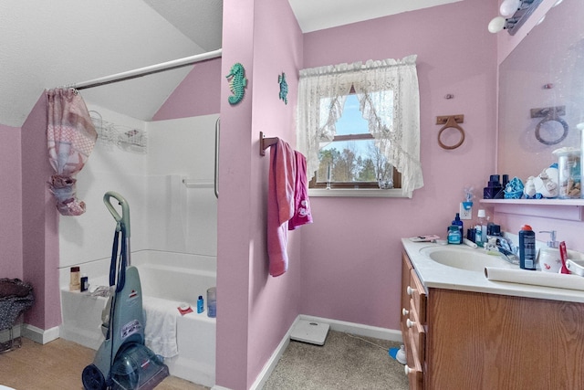 512 Kalkaska Rd NW, Kalkaska, MI 49646 - full bathroom with vanity, shower / washtub combination, baseboards, and lofted ceiling