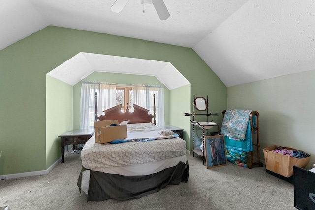 512 Kalkaska Rd NW, Kalkaska, MI 49646 - bedroom featuring vaulted ceiling, carpet flooring, a ceiling fan, a textured ceiling, and baseboards