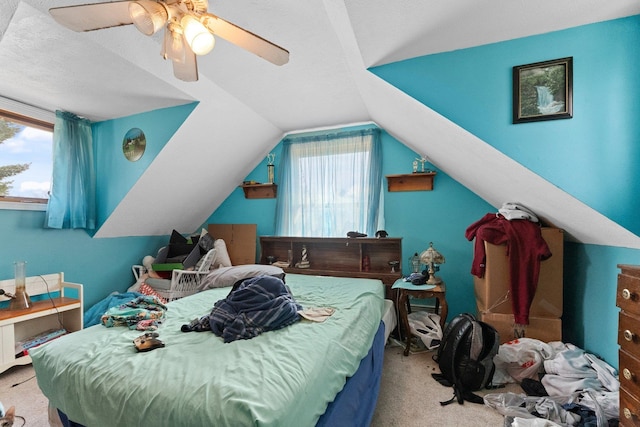 512 Kalkaska Rd NW, Kalkaska, MI 49646 - bedroom featuring carpet flooring, multiple windows, lofted ceiling, and a ceiling fan