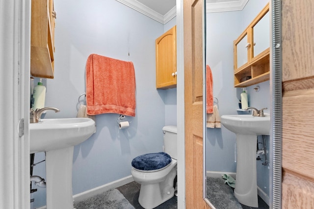 512 Kalkaska Rd NW, Kalkaska, MI 49646 - bathroom with crown molding, toilet, baseboards, and a sink