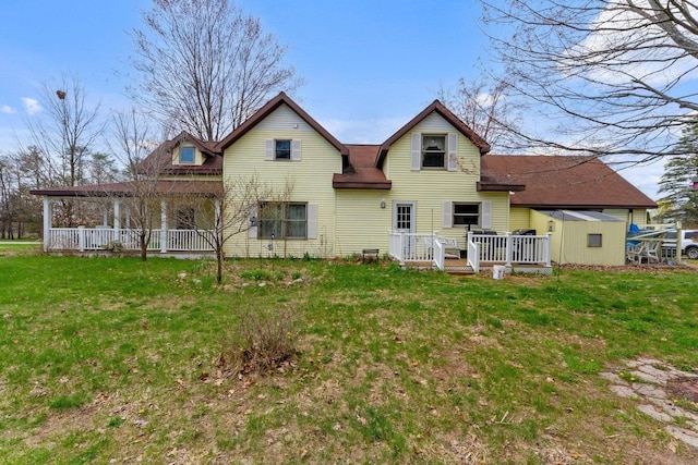 512 Kalkaska Rd NW, Kalkaska, MI 49646 - rear view of property with a lawn, covered porch, and a deck