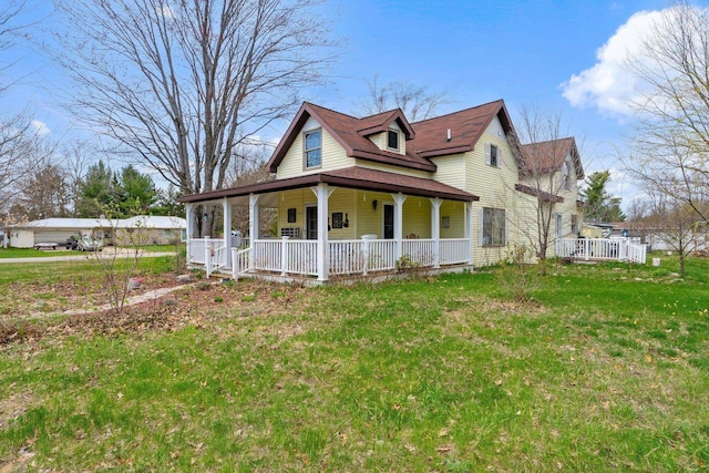 512 Kalkaska Rd NW, Kalkaska, MI 49646 - view of property exterior with covered porch and a lawn