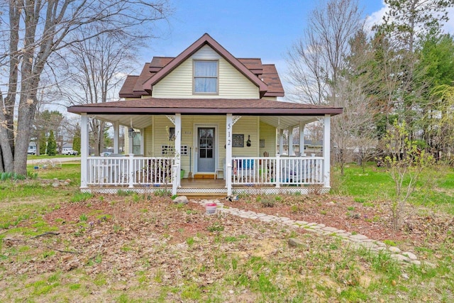 512 Kalkaska Rd NW, Kalkaska, MI 49646 - farmhouse inspired home with covered porch and roof with shingles