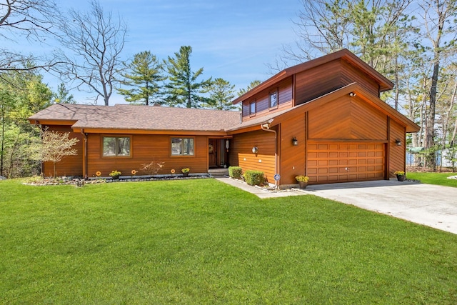 7017 Loud Dr, Oscoda, MI 48750 - view of front facade with a front yard, driveway, an attached garage, and roof with shingles