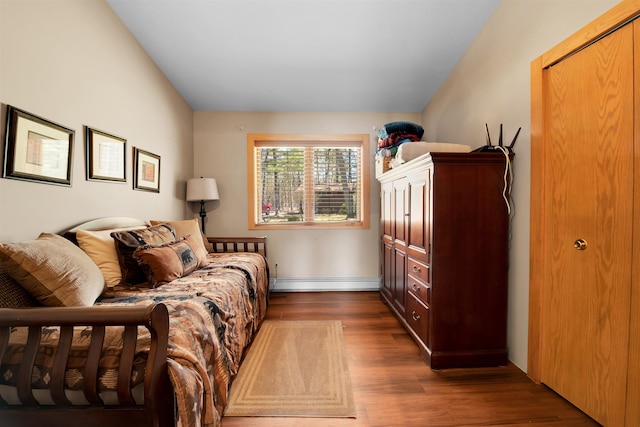 7017 Loud Dr, Oscoda, MI 48750 - bedroom with baseboard heating and wood finished floors