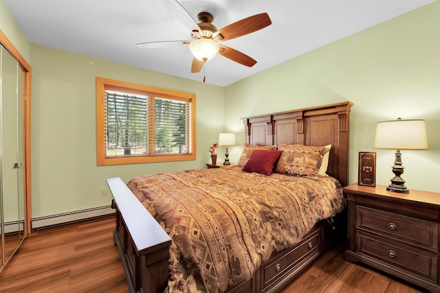 7017 Loud Dr, Oscoda, MI 48750 - bedroom featuring a baseboard radiator, dark wood-style floors, ceiling fan, and a closet