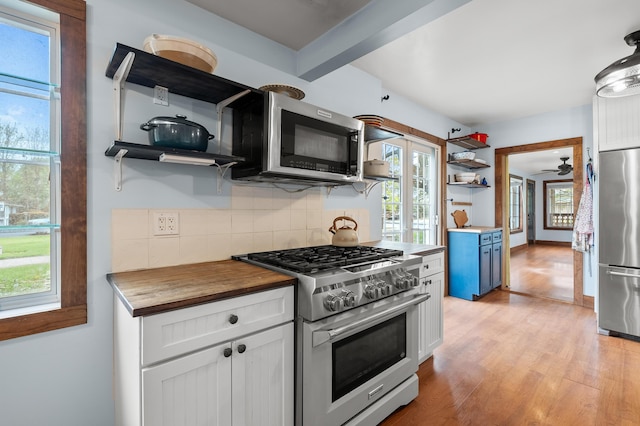 3694 Kerlikowske Rd, Coloma, MI 49038 - kitchen featuring appliances with stainless steel finishes, open shelves, wood counters, backsplash, and light wood-style floors