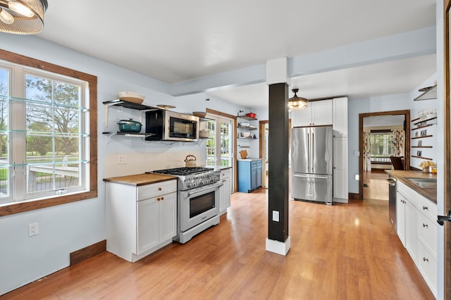 3694 Kerlikowske Rd, Coloma, MI 49038 - kitchen with high quality appliances, white cabinets, light wood-type flooring, and open shelves