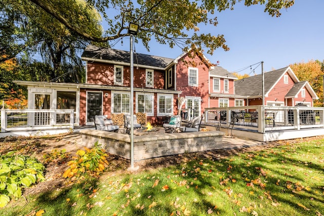 3694 Kerlikowske Rd, Coloma, MI 49038 - back of house with a wooden deck, an outdoor fire pit, a lawn, and a patio