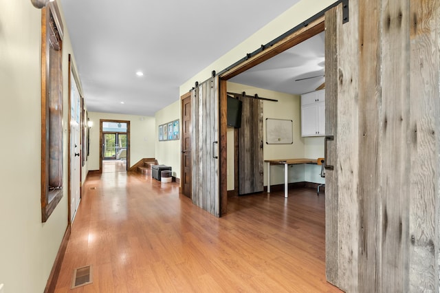 3694 Kerlikowske Rd, Coloma, MI 49038 - hallway with a barn door, light wood-style flooring, baseboards, and recessed lighting