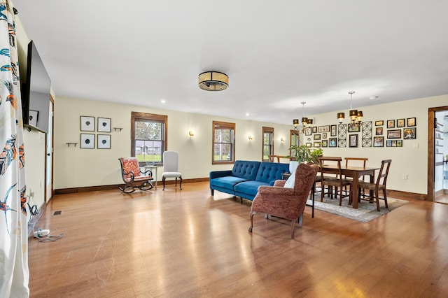 3694 Kerlikowske Rd, Coloma, MI 49038 - living area featuring light wood-style floors, baseboards, and a chandelier