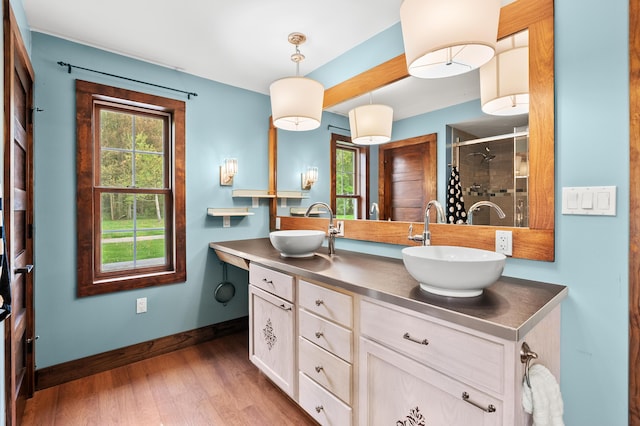 3694 Kerlikowske Rd, Coloma, MI 49038 - bathroom with wood finished floors, a shower stall, double vanity, and baseboards