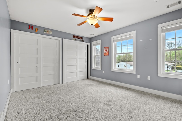 3694 Kerlikowske Rd, Coloma, MI 49038 - unfurnished bedroom with multiple windows, baseboards, carpet, and ceiling fan