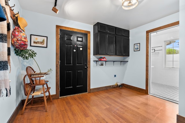 3694 Kerlikowske Rd, Coloma, MI 49038 - clothes washing area featuring cabinet space, electric dryer hookup, light wood finished floors, and baseboards