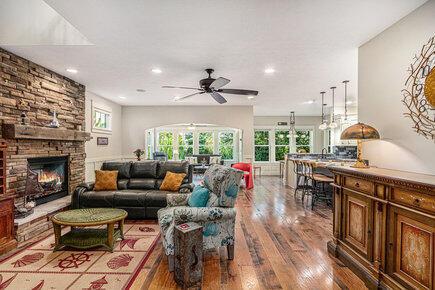 7251 E Beach Dr, South Haven, MI 49090 - living room featuring wood finished floors, a stone fireplace, a ceiling fan, and recessed lighting