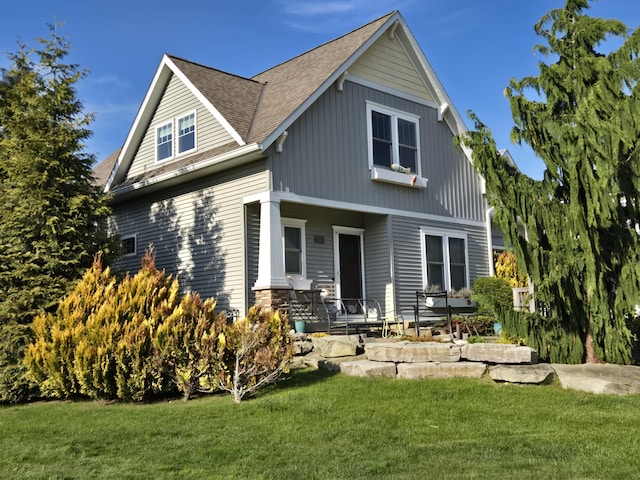 7251 E Beach Dr, South Haven, MI 49090 - rear view of house featuring a yard and roof with shingles