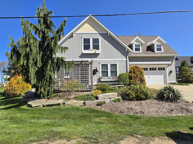 7251 E Beach Dr, South Haven, MI 49090 - view of front facade with concrete driveway, a front lawn, a garage, and board and batten siding